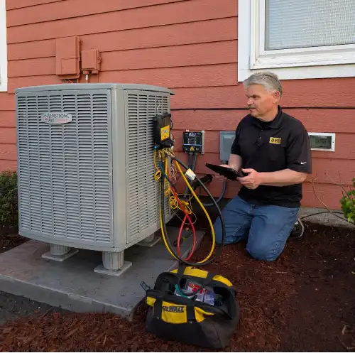 Dye Plumbing & Heating technician running diagnostics on an A/C unit
