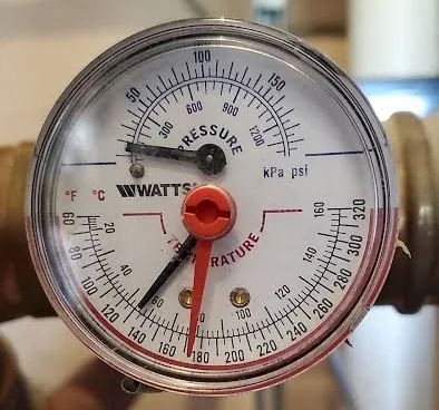 Watts tridicator on a residential hot-water boiler, the combination gauge that shows system pressure in psi and water temperature in degrees